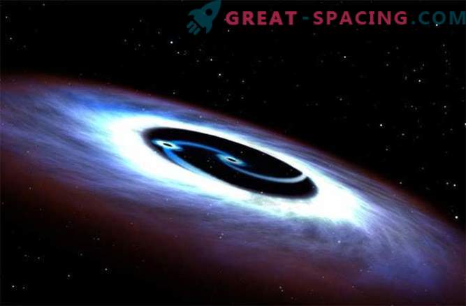 Zwarte gaten draaien rond een quasar in een dodelijke strijd